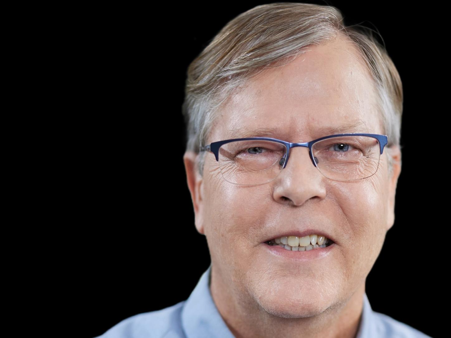portrait of colleague Ross in front of a black background
