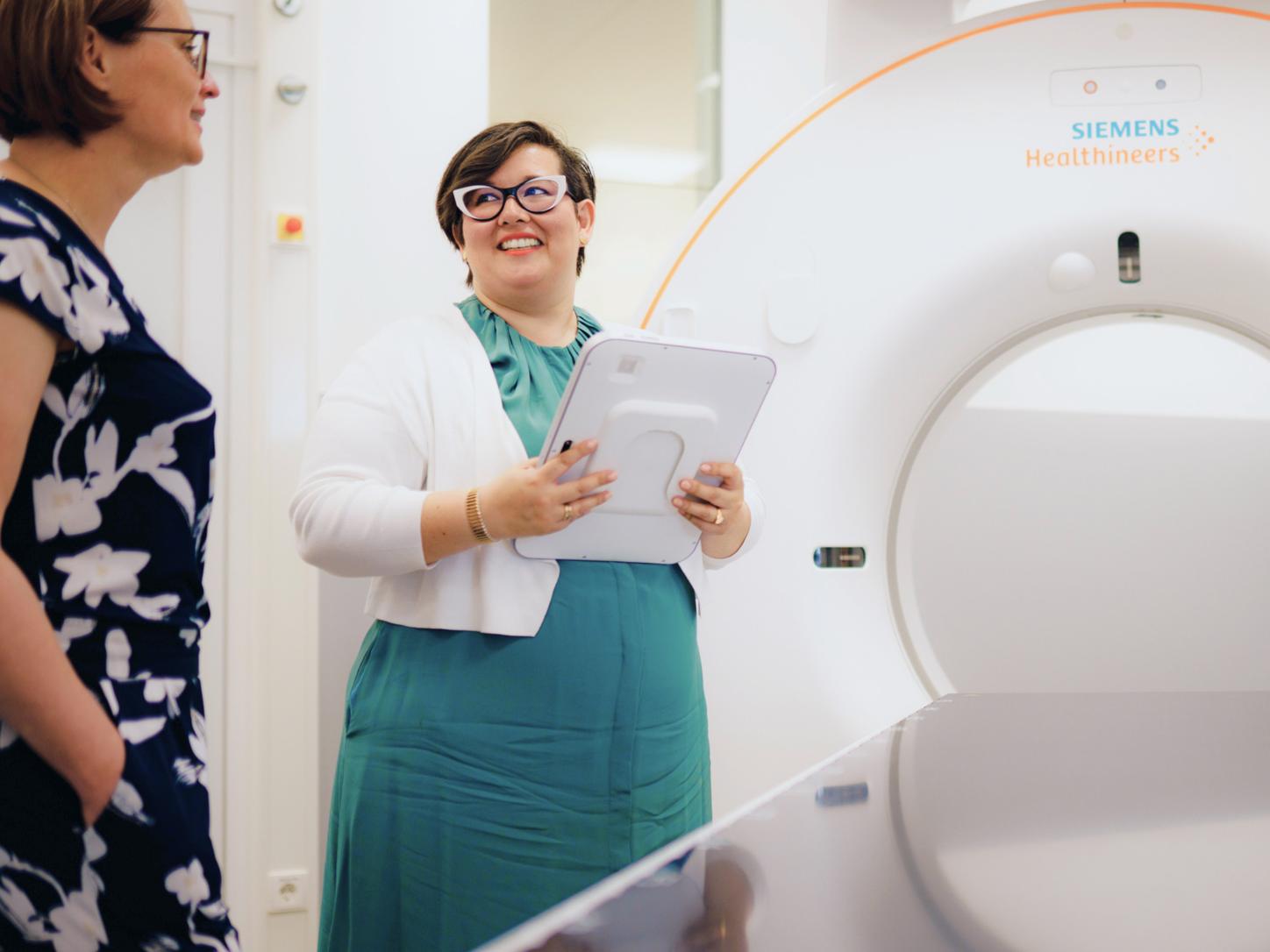 Two colleagues talking in front of an MRI