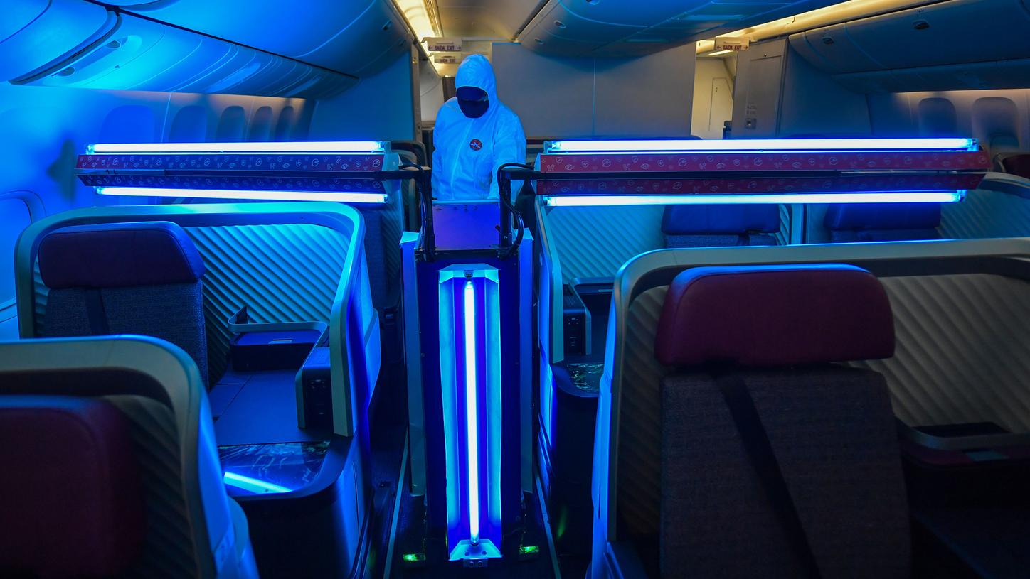 Cleaning robot disinfects an aircraft using ultraviolet light.