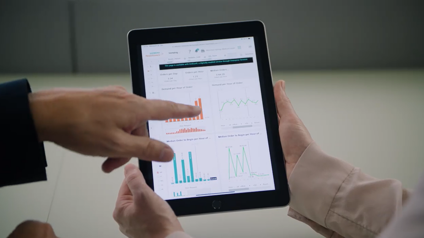 Siemens Healthineers expert showing the benefits of ActExcell on a tablet